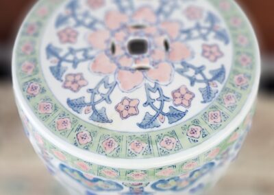 Decorative porcelain stool with floral patterns.