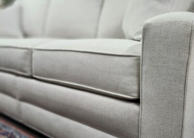 White sofa on patterned rug.