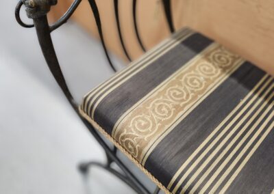 Decorative chair with striped cushion seat.
