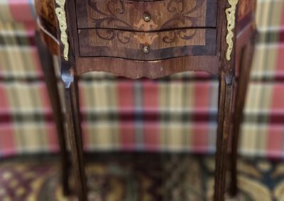 Antique wooden side table with intricate design.