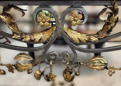 Ornate metalwork with gold floral accents.
