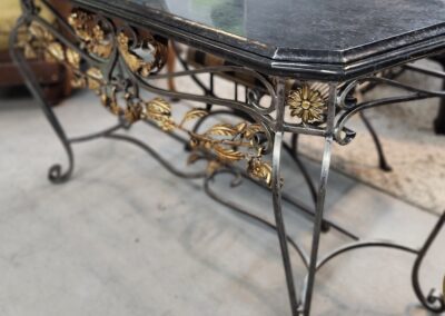 Ornate metal table with floral design.