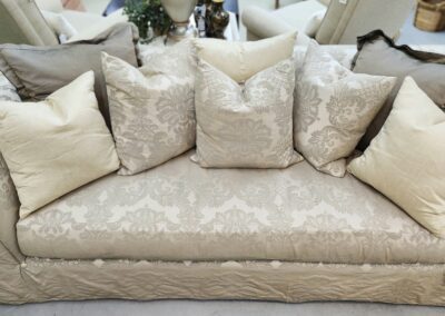Elegant sofa with patterned cushions and pillows.