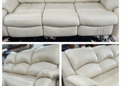 Beige leather sofa with reclining seats.