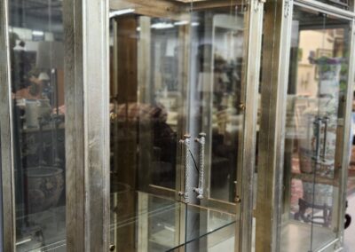 Ornate glass display cabinets with arched tops.