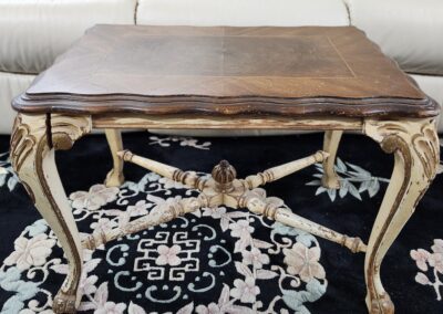 Antique wooden table on floral patterned rug.
