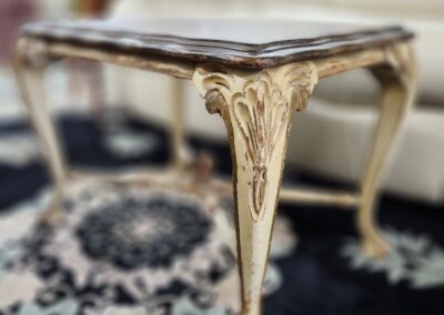 Ornate antique table with intricate leg design.