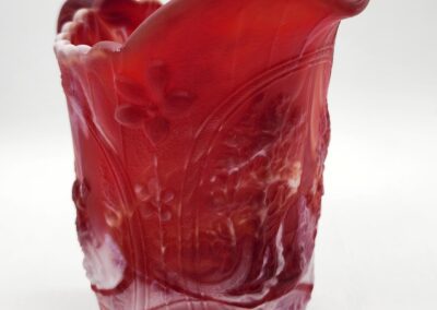 Red decorative vase with floral patterns.