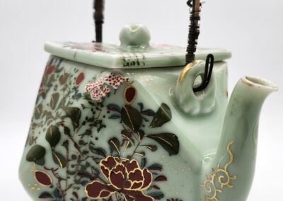 Intricately designed floral ceramic teapot.