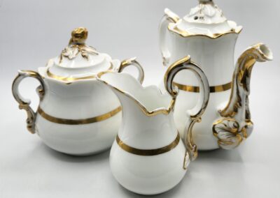 White and gold ornate tea set.