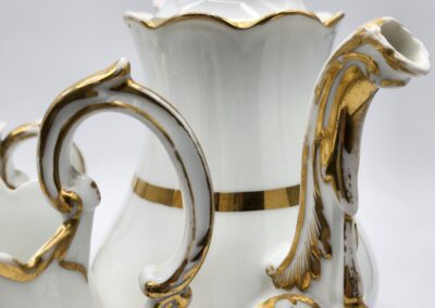 Ornate white and gold porcelain tea set.