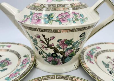 Floral porcelain teapot and plates set.