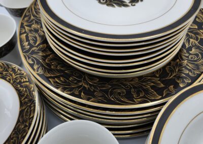 Elegant black and gold dinnerware set displayed.