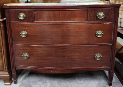 Vintage wooden dresser with brass handles.