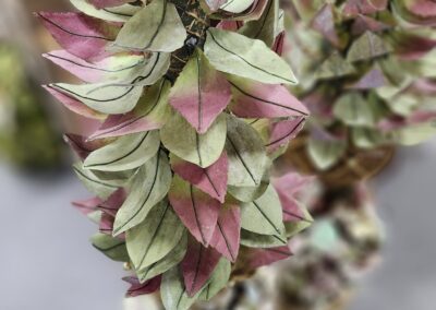 Hanging decorative leaves in pink and green.