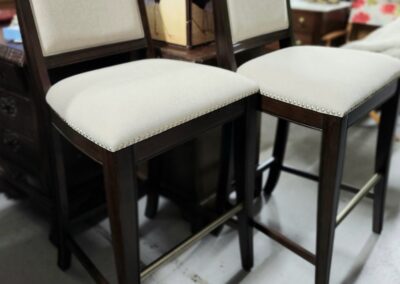 Two tall cushioned chairs with dark wood.