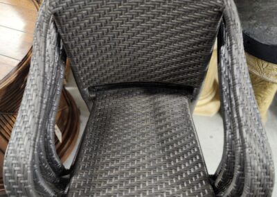 Stacked wicker chairs in a store display.