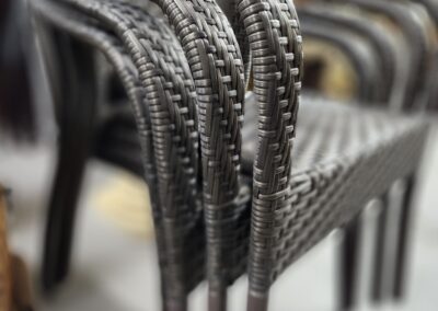 Stacked wicker chairs in a row.