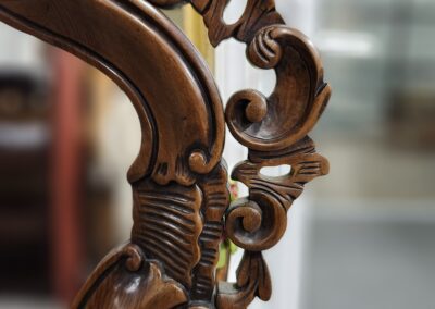 Ornate wooden carving with intricate scroll design.