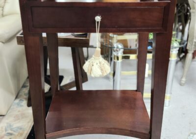 Wooden side table with single drawer.