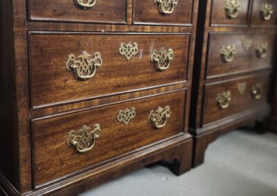 Wooden dressers with ornate brass handles.