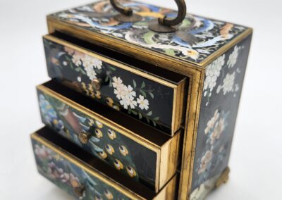 Ornate miniature chest with floral design.