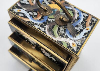 Decorative jewelry box with open drawers.