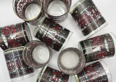 Colorful patterned drinking glasses arranged randomly.