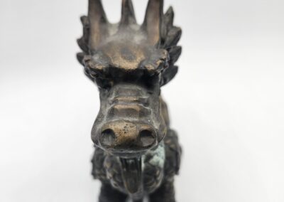 Bronze dragon statue on white background.