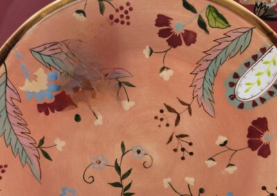 Decorative plates with floral patterns displayed upright.