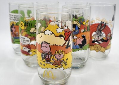 Cartoon-themed collectible glasses with vibrant designs.