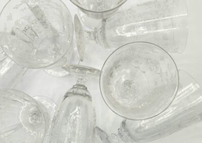 Clear etched glass goblets on white background.