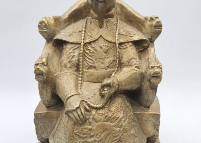 Golden statue of a seated historical figure.