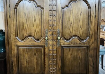 Ornate wooden armoire with carved details.
