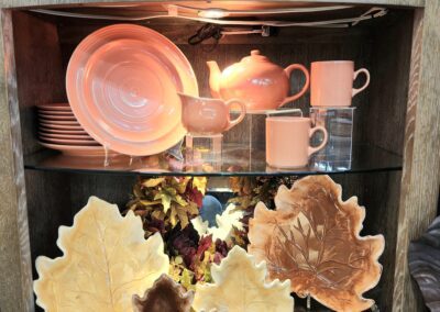 Ceramic dishes and leaf-shaped plates displayed.