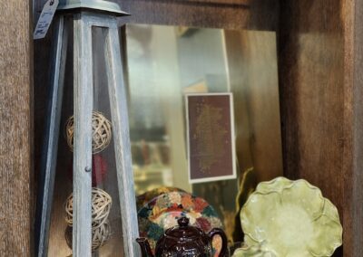 Decorative shelf with plates and lantern display.