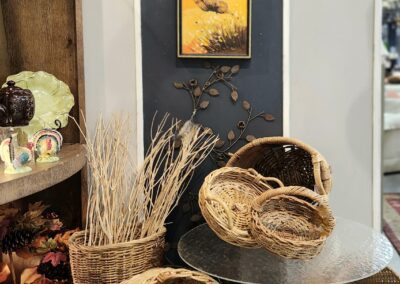 Wicker baskets and framed art on display.