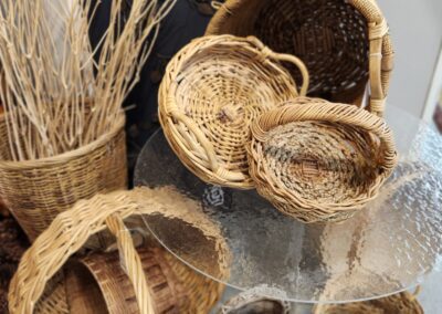 Wicker baskets displayed on glass table.