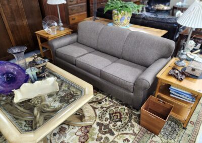 Living room with sofa and glass table.