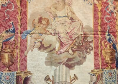 Angel and cherub on ornate tapestry background.
