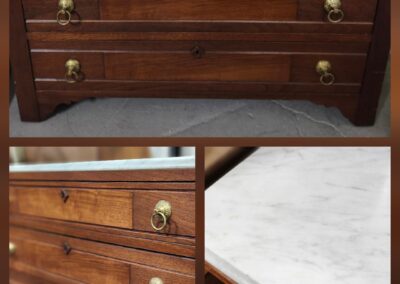 Wooden dresser with brass handles, marble top.