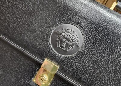 Black leather briefcase with embossed logo.