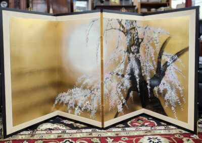 Japanese folding screen with cherry blossom design.