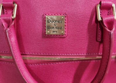 Pink Dooney & Bourke handbag with label.