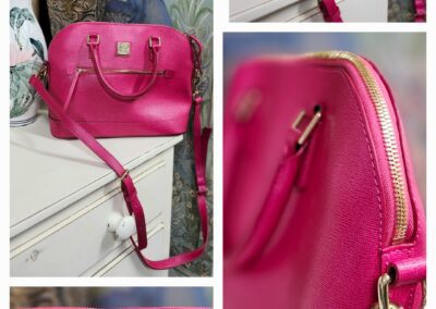 Pink handbag on white dresser, floral decor.