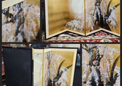 Golden folding screen with cherry blossom painting.