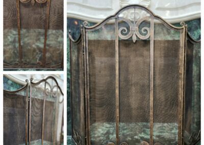 Ornate metal fireplace screen with scroll design.