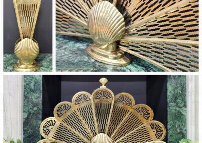 Ornate brass fireplace screen with fan design.
