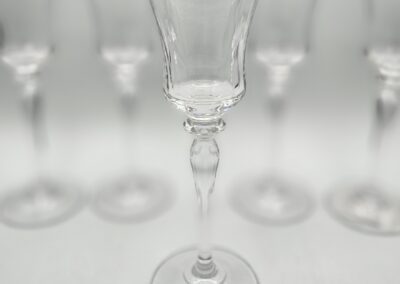 Crystal wine glasses with silver rims.