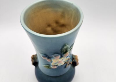 Blue ceramic vase with floral design.